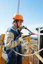 Worker builder at facade installation work with riveting hammer