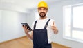 Worker or builder with tablet pc showing thumbs up Royalty Free Stock Photo