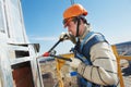 Worker builders at facade tile installation Royalty Free Stock Photo