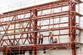 Worker builders working on roof structure on construction site.Building team.