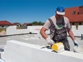 Worker building concrete wall