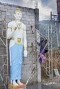 Worker building huge buddhist statue