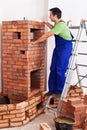 Worker building masonry heater - checking level of the inner firebox Royalty Free Stock Photo