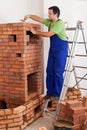 Worker building masonry heater Royalty Free Stock Photo