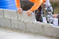 Worker building masonry house wall with bricks Royalty Free Stock Photo