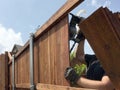 A worker is building a nice fence