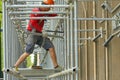 Worker building a scaffolding in renovation site