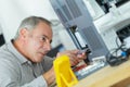 Worker calibrating a printer