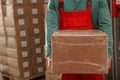 Worker with cardboard box in warehouse, closeup. Wholesaling