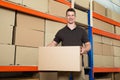 Worker With Cardboard Box In Warehouse Royalty Free Stock Photo