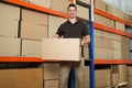 Worker With Cardboard Box In Warehouse Royalty Free Stock Photo