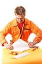 Worker carefully folds a paper