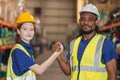 Worker in cargo warehouse teamwork support trainee young women with African foreman help together Royalty Free Stock Photo