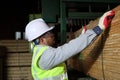 Worker carpenter measures the wood
