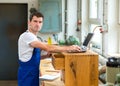 Worker in a carpenter's workshop with computer Royalty Free Stock Photo