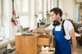 Worker in a carpenter's workshop with computer Royalty Free Stock Photo