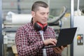 worker in carpenters workshop with clipboard and computer Royalty Free Stock Photo