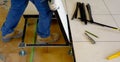 Worker carries a floating floor on steel feet