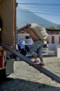 Worker carries heavy sacks of coffee beans