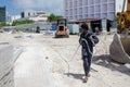 Worker carries hose