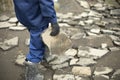 Worker carries stone. Cleaning of construction waste. Broken stone