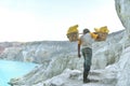 Worker carries sulfur sulphur inside Kawah Ijen Volcano