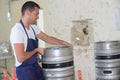 Worker carrying barrel with beer at brewery Royalty Free Stock Photo