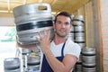 Worker carrying barrel with beer at brewery Royalty Free Stock Photo