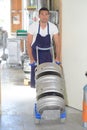 Worker carrying barrel with beer at brewery Royalty Free Stock Photo