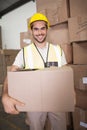 Worker carrying box in warehouse Royalty Free Stock Photo