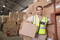 Worker carrying box in warehouse Royalty Free Stock Photo