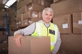 Worker carrying box in warehouse Royalty Free Stock Photo