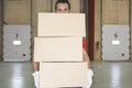 Worker Carrying Boxes Against Dock Doors Royalty Free Stock Photo