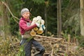 Worker Carrying Firewood Rounds