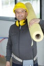 worker carrying insulation roll Royalty Free Stock Photo