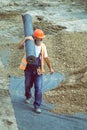 Worker carrying rolls of geotextile insulation 4