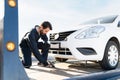 Worker chaining a dead car to the tow truck platform Royalty Free Stock Photo