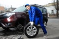 Worker changing car wheel at service Royalty Free Stock Photo