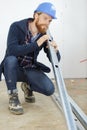 worker checking metal plank straightness Royalty Free Stock Photo