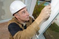 Worker checking newly installed window Royalty Free Stock Photo