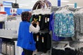 Worker checking price tag for display clothes on sale inside Walmart store