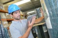 Worker checking product against tablet Royalty Free Stock Photo