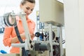 Worker checking textile label fresh from the printing machine Royalty Free Stock Photo