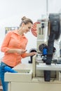 Worker checking textile label fresh from the printing machine Royalty Free Stock Photo