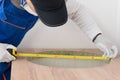 A worker checks the hole for installing a sink in the countertop of kitchen furniture Royalty Free Stock Photo