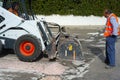 Worker checks the progress of the Milling of asphalt