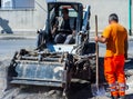 Worker checks the progress of the Milling of asphalt