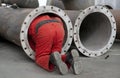 Worker checks a steel pipe