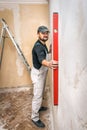 The worker checks the wall level Royalty Free Stock Photo