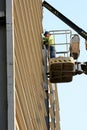 Worker on cherry picker in construction site Royalty Free Stock Photo